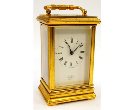 A St James brass cased carriage clock, the enamel dial bearing Roman numerals, with key, 13cm high.