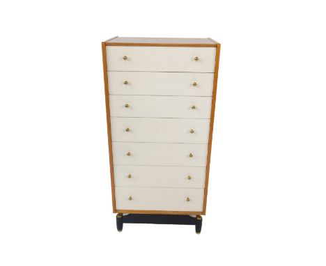 A G-Plan light oak chest of drawers, with seven white painted drawers, raised on a black metal and brass capped base, 125cm H