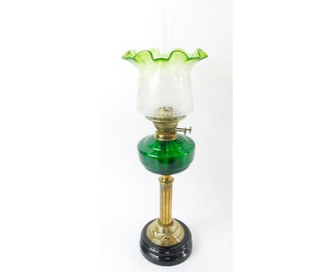 An Eltex brass oil lamp, with a green glass reservoir, raised on a socle base, with clear to green etched glass shade, 70cm h