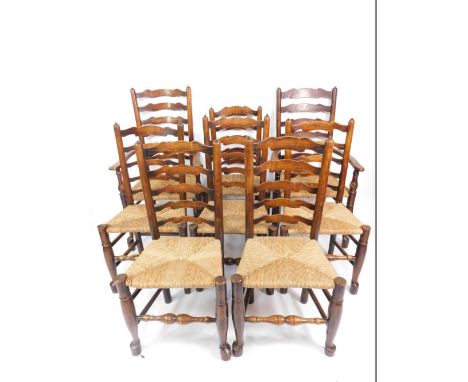 A set of eight 18thC oak ladder back dining chairs, possibly Welsh Borders, with rush seats, raised on turned legs, united by