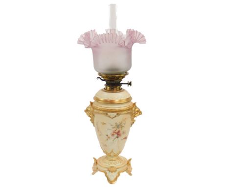 A Royal Worcester late 19thC blush porcelain oil lamp, of twin mask head ovoid form, painted with flowers and butterflies, ra