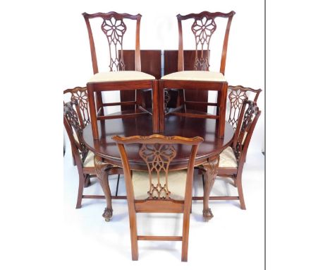 A Georgian style mahogany oval wind-out dining table, with one additional leaf, raised on carved cabriole legs and ball and c