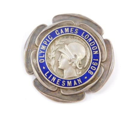 An Olympic Games 1908 Linesman lapel badge, silver and blue and enamel, modelled by B MacKennal, depicting the head of Palas 