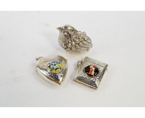 Three silver vesta cases, one heart shaped with an enamel reserve roundel printed with a cricket match, another rectangular w