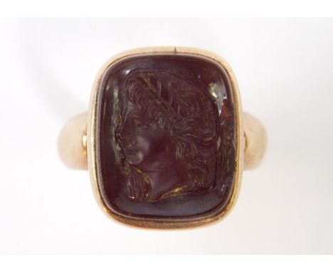 A gentleman's cornelian set signet ring, cameo carved bust portrait of a lady, in yellow metal stamped 18ct, size O/P, 5.5g.