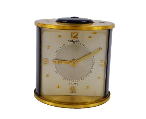 A Jaeger brass and black plastic cased alarm clock, of cylindrical form, white square dial bearing Arabic numerals at quarter