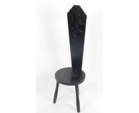 A Studio of Art and Antiquity Torbay ebonised spinning chair, carved with rampant lions and Celtic knot motifs, raised on thr