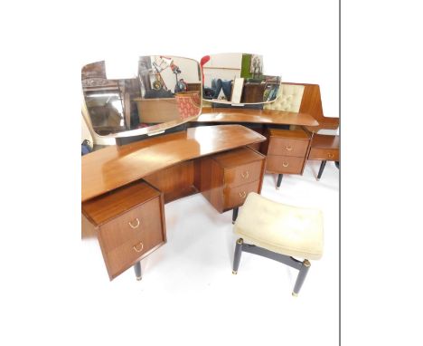 G-Plan furniture, comprising 1960's concave teak and ebonised dressing table, with a glass mirror, and four drawers, raised o