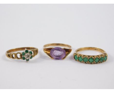 A 9ct gold and amethyst single stone ring, size P, 9ct emerald and diamond flower head ring, size M, and a 9ct gold and emera