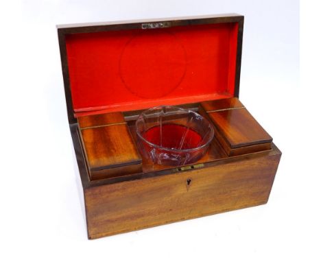 A Georgian mahogany tea caddy, of rectangular section, opening to reveal two cannisters flanking a recess with a glass mixing