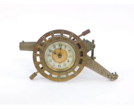 A WWI period brass cased strut clock, manufactured by The British United Clock Company Ltd, Birmingham, the case cast as a he