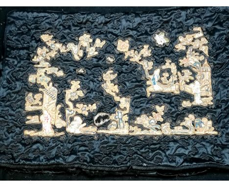 An antique black silk cushion cover with applied Chinese silk embroidered decoration, 64cm x 44cm, one hole as photographed, 