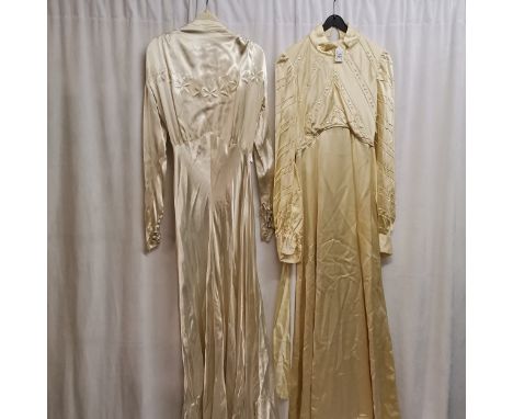 2 1940s wedding dresses, 1 is a cream satin dress with pearl trim, slight staining to hem. Chest 70cm. Together with ivory sa