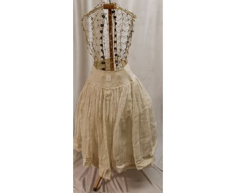 Vintage wire work mannequin with muslin petticoat on a wooden adjustable stand 