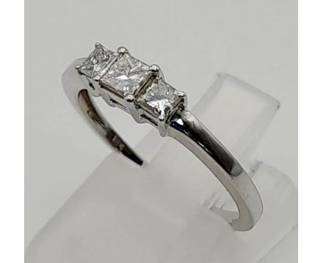 An 18 K white gold ring with a trilogy of square diamonds. Ring size: N, weight: 2.43 g. 