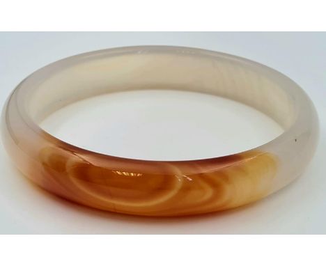 A Red and White Jade Bangle. Inner diameter 7cm. 