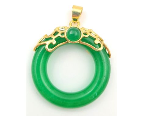 A Green Jade Small Circular Necklace. Attached to a yellow metal backing. 3cm. 