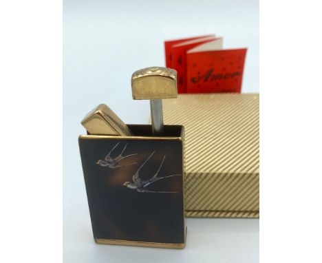 Vintage 1950/60?s AMOR perfume atomiser in the form of a lighter, having tortoiseshell case with birds in flight design.Full 