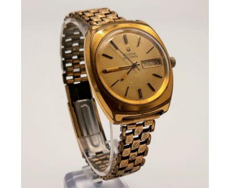 A Vintage Bulova Accutron Gents Watch. Gold plated strap and case - 38mm. Gold dial with day and date window. Quartz movement