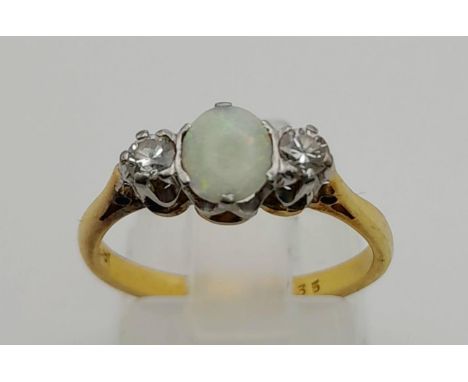 An 18 K yellow gold ring with an opal cabochon and two brilliant cut diamonds. Ring size: L, weight: 2.45 g. 