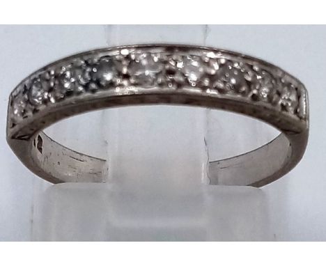 An 18 K white gold, 1/2 eternity ring with brilliant cut diamonds. ring size: K, weight: 2.51 g. 