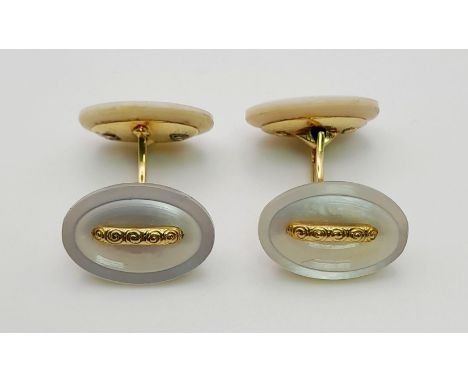 A PAIR OF MOTHER OF PEARL CUFF LINKS SET IN 14K GOLD.  7.3gms 