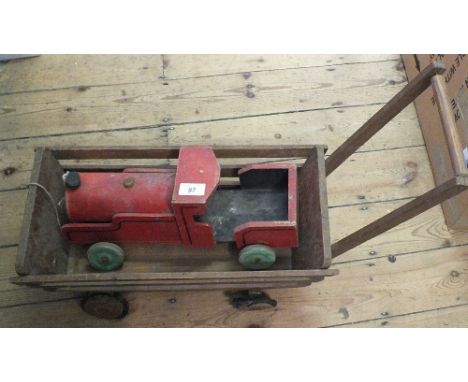 A wooden articulated snake, a tin plate truck plus a wooden trolley and steam engine