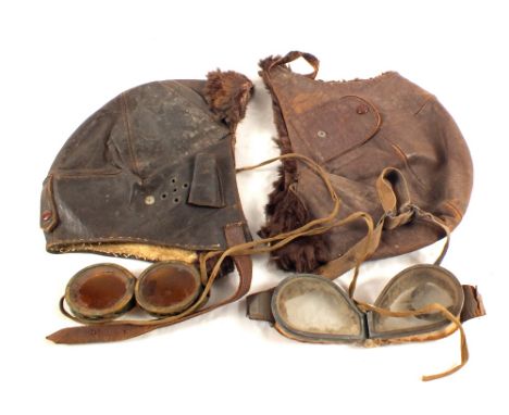 Two vintage leather helmets with two sets of goggles