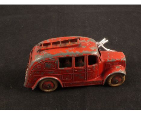 A rare Dinky Toys 25k streamline fire engine with six tin plate men (ladder broken)