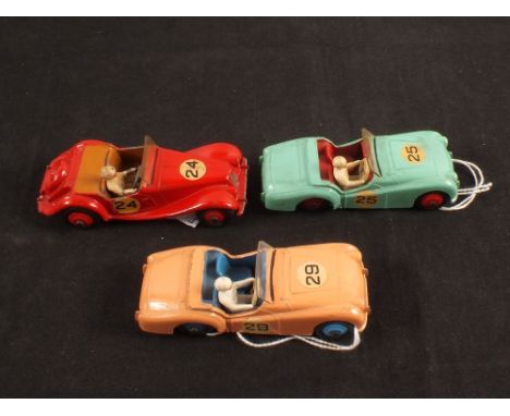 Three Dinky Toys racing cars, two III Triumph TR2 sports car one pink No.29 other light green No.25 plus 108 M.G.Midget in re