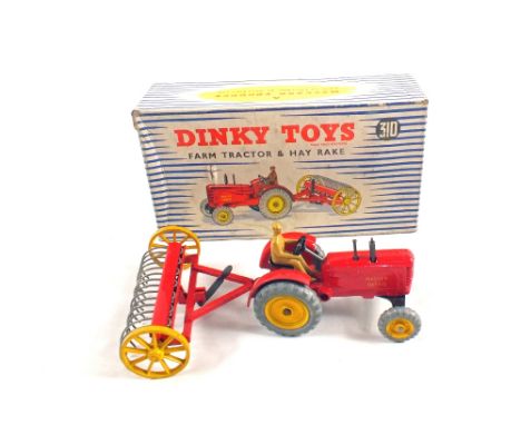 A boxed Dinky toys 310 Massey Harris farm tractor and hay rake in box type 2
