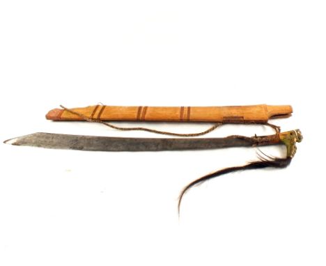 A 19th Century Bayak head-hunters sword with scabbard (the carved grip as found)