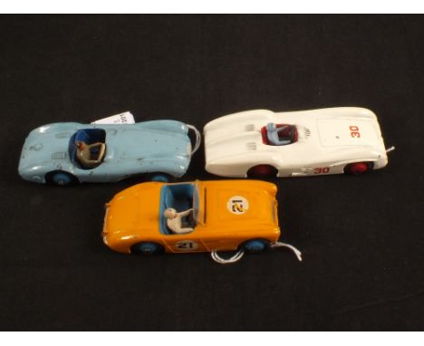 Three Dinky Toys racing cars, 108 Austin Healey in yellow No.21, 237 Mercedes Benz in white No.30 and 104 Aston Martin in lig