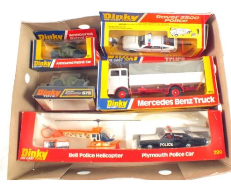 A box of five boxed Dinkys, Rouer 264 police car, Mercedes lorry 940, two Army armoured cars 667 and 676, one crash squad set