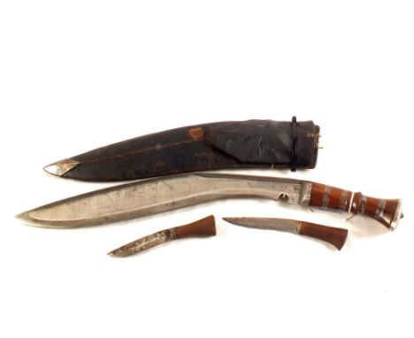 A vintage Kukri with white metal embellished wooden grip and its leather sheath (as found)