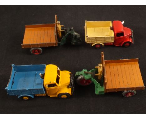 Four Dinky Toys, two 410 Bedford tipper truck yellow/blue and red/cream and two 27g Motocraft dark green/tan and light green/