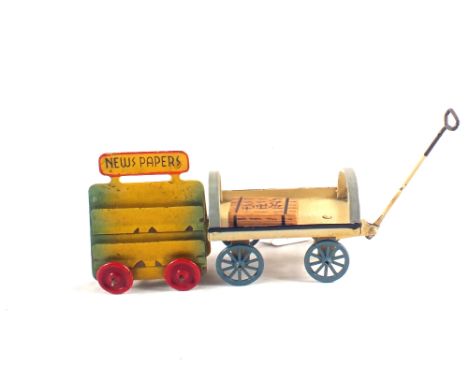 A tin plate railway platform hand cart and a die cast newspaper trolley, possibly by Marklin