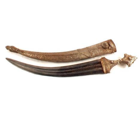 A Middle Eastern dagger within its white metal covered scabbard