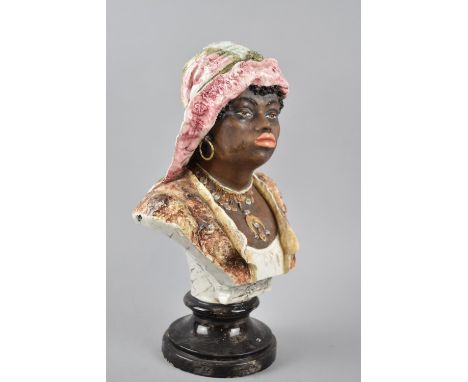 A Continental Ceramic Bust of an African Lady with Necklace, on Turned Socle, 36cm High 