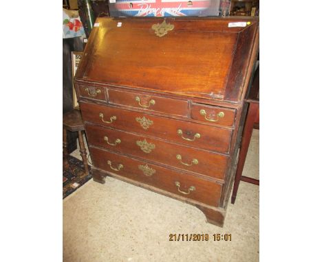 LATE 18TH CENTURY OAK FRAMED DROP FRONTED BUREAU WITH FITTED INTERIOR WITH THREE DRAWERS OVER THREE FULL WIDTH DRAWERS RAISED