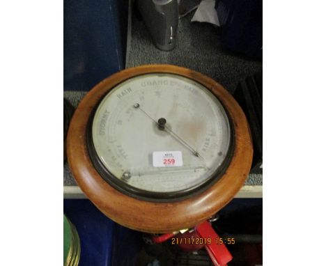 CIRCULAR BAROMETER IN A WALNUT FRAME, 27CM DIAM