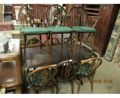 ERCOL RECTANGULAR DINING TABLE TOGETHER WITH A SET OF NINE ERCOL HARD SEATED DINING CHAIRS WITH FLEUR DE LYS BACKS COMPRISING