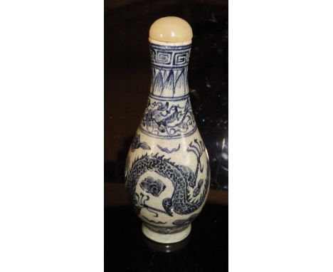 A Chinese porcelain gourd-shaped scent bottle decorated in blues with five toed dragon, with jade bead stopper, raised on a c