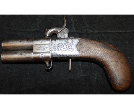 A 19th Century Continental hammer action twin-barrelled revolving pistol, the hammer formed as a fish, the side plate with sc