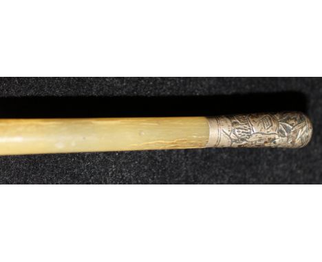 A 19th Century rhino horn swagger stick with Chinese white metal pommel embossed with two figures playing chequers in a leafy