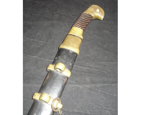 A Russian military Shasqua sword, the single edge curved blade dated 1940, the spiral wooden grip with brass mounts bearing R