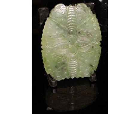 A Chinese spinach jade panel of insect or leaf form, carved to one side only, 4.8 cm long   CONDITION REPORTS  Has a small ch