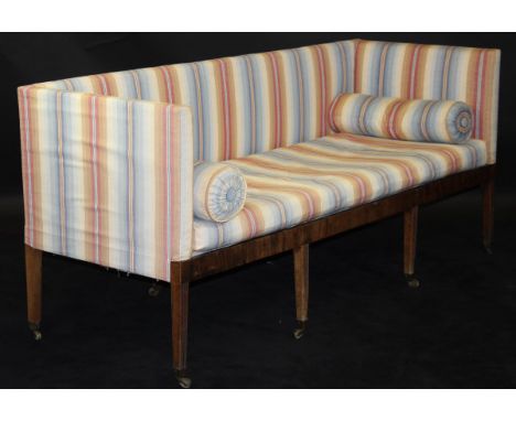 A Regency sofa, the square back and arms above a plain apron, raised on four square tapering and reeded front legs to brass c