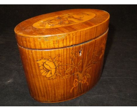 A George III harewood and marquetry inlaid tea caddy of oval form, the hinged lidded top set with satinwood disc bearing marq