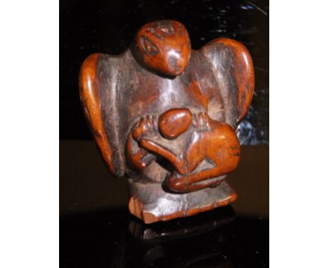 A 19th Century Chinese carved wood netsuke as a figure kneeling before an eagle, 3.8 cm long